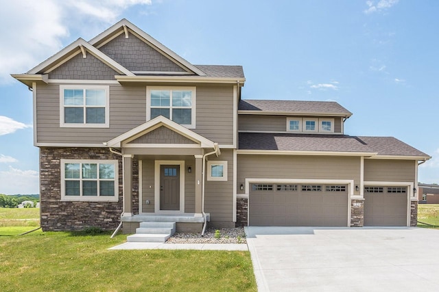 craftsman-style home featuring a garage and a front lawn