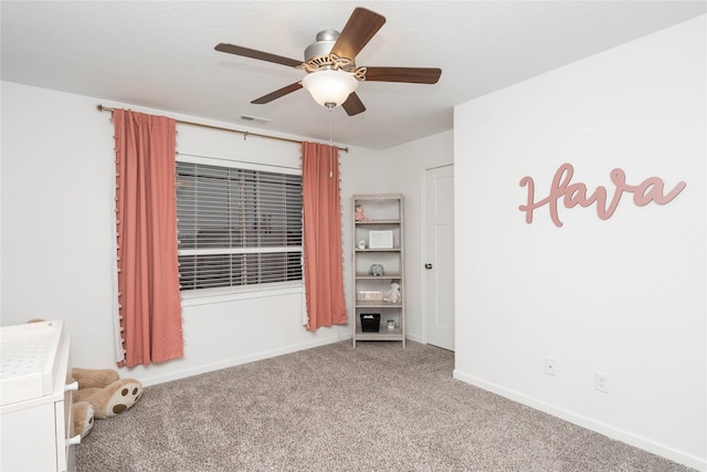 carpeted spare room with a ceiling fan, baseboards, and visible vents