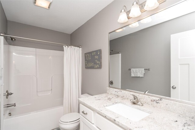 bathroom with vanity, toilet, and shower / tub combo