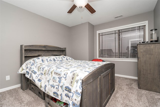 carpeted bedroom with a ceiling fan, baseboards, and visible vents