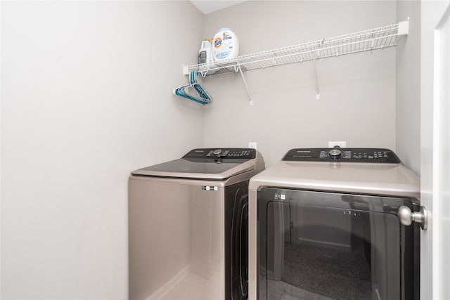 washroom featuring laundry area and washer and clothes dryer