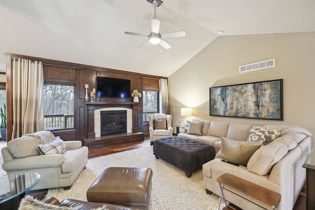 living room featuring hardwood / wood-style flooring, ceiling fan, and lofted ceiling