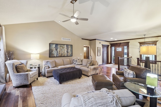 living room featuring lofted ceiling, ceiling fan, wood-type flooring, and crown molding