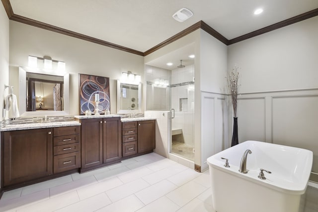 bathroom featuring tile patterned flooring, vanity, separate shower and tub, and crown molding