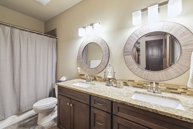 bathroom featuring backsplash, vanity, and toilet