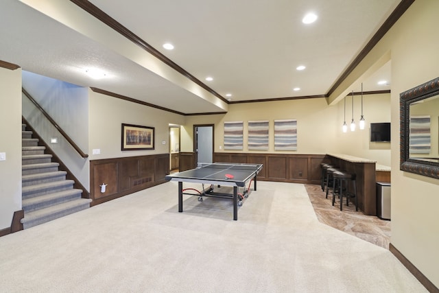 recreation room with light carpet and ornamental molding