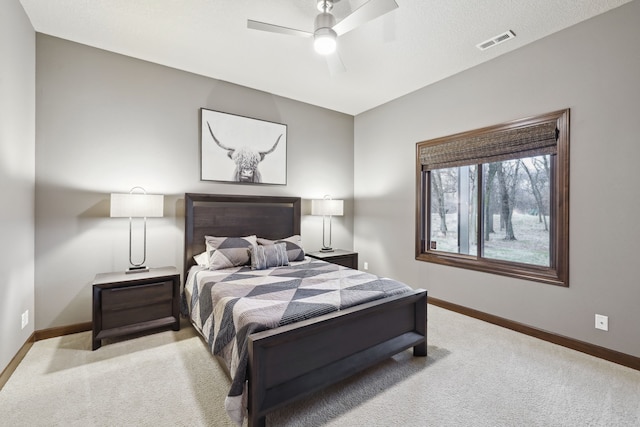 carpeted bedroom featuring a textured ceiling and ceiling fan