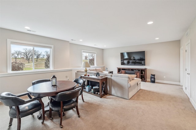 living area with recessed lighting, light colored carpet, visible vents, and baseboards