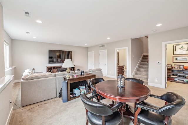 dining space with light carpet, stairs, visible vents, and recessed lighting