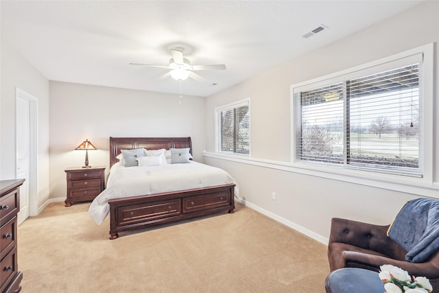 bedroom featuring visible vents, ceiling fan, light carpet, and baseboards