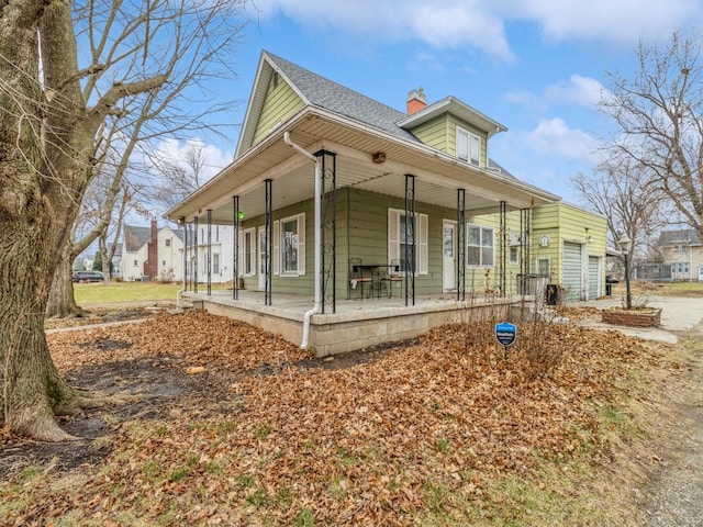 view of property exterior featuring covered porch and a garage