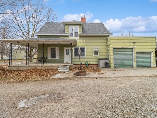 view of front of property with a porch and a garage