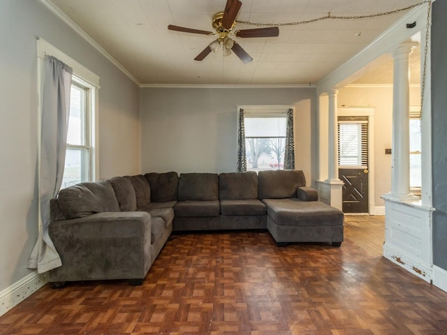 living room featuring dark parquet flooring, ornate columns, ceiling fan, and ornamental molding