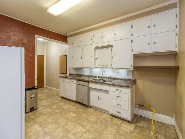 kitchen with crown molding, sink, white cabinets, and white refrigerator