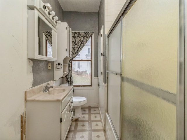 bathroom featuring tile patterned floors, vanity, and toilet