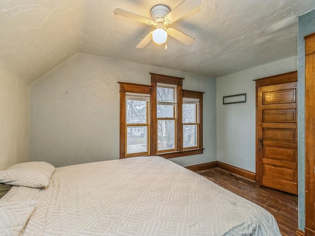 bedroom with wood-type flooring, ceiling fan, and lofted ceiling