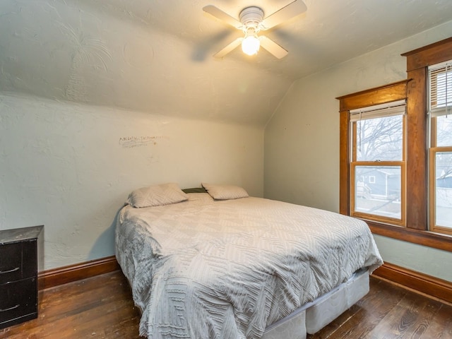 bedroom featuring dark hardwood / wood-style flooring, ceiling fan, and lofted ceiling