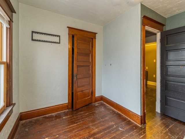 unfurnished bedroom featuring dark hardwood / wood-style flooring