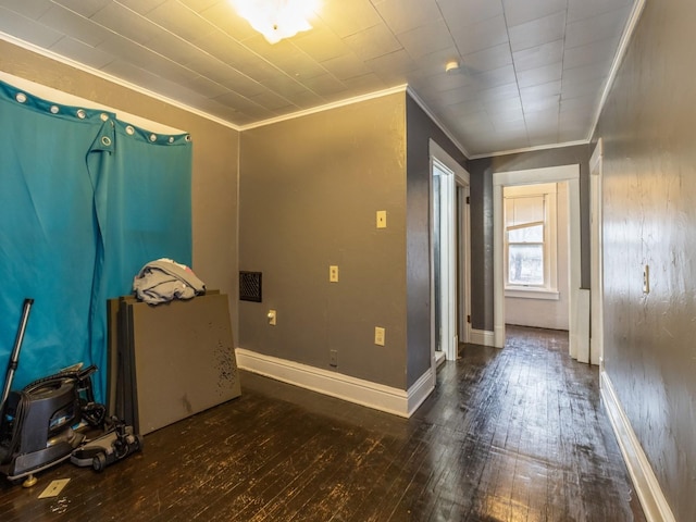 empty room featuring crown molding and dark hardwood / wood-style flooring