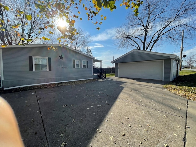 exterior space featuring a garage and an outdoor structure