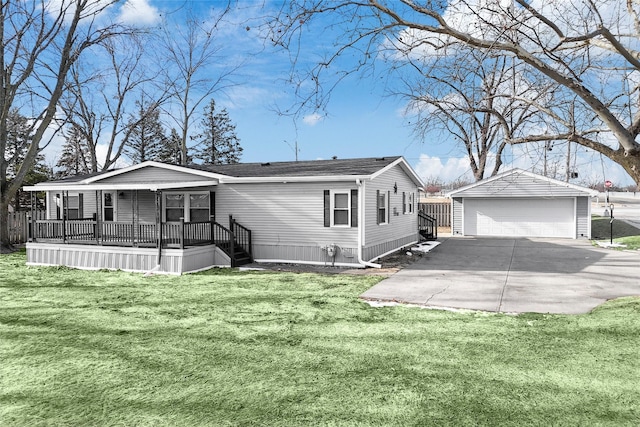 view of front of property with a garage, covered porch, a front yard, and an outdoor structure