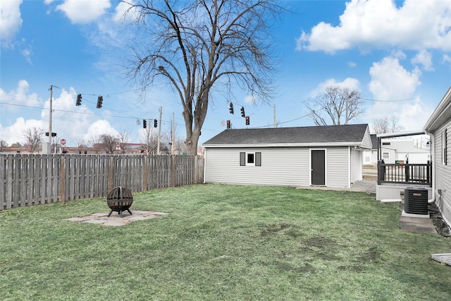 view of yard featuring an outbuilding, an outdoor fire pit, and central AC