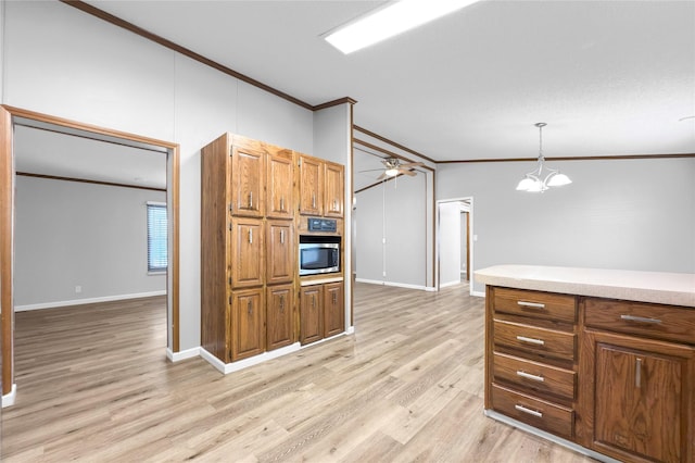 kitchen featuring pendant lighting, ceiling fan with notable chandelier, ornamental molding, light hardwood / wood-style floors, and lofted ceiling