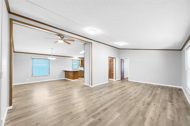 unfurnished living room featuring light wood-type flooring, ceiling fan with notable chandelier, ornamental molding, and a textured ceiling