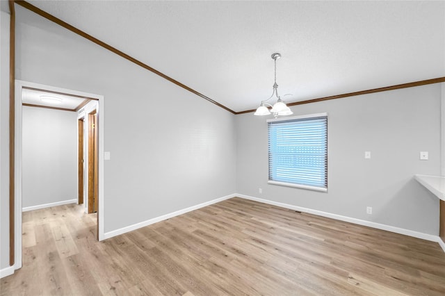 unfurnished dining area featuring vaulted ceiling, light hardwood / wood-style flooring, crown molding, and an inviting chandelier