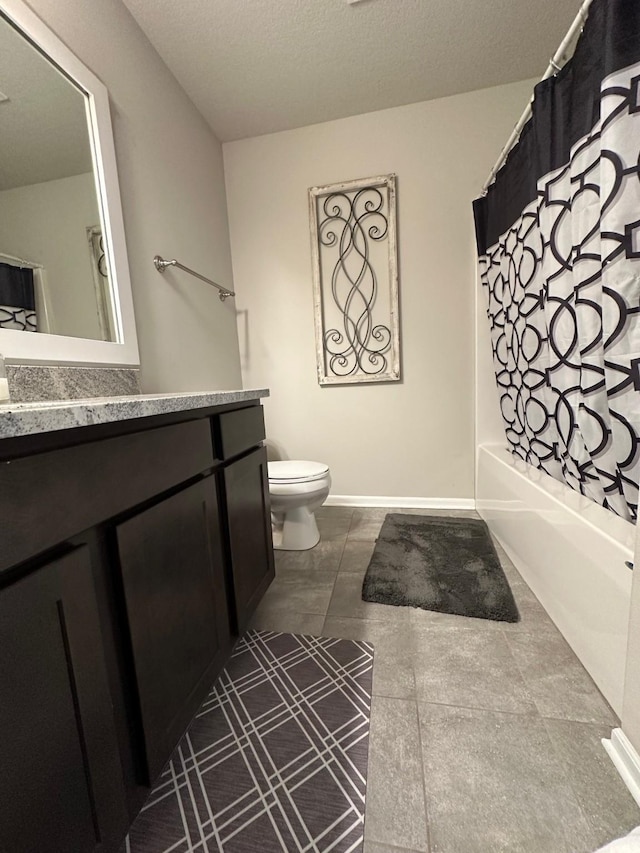 full bathroom with vanity, toilet, a textured ceiling, and shower / tub combo