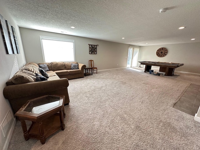 living room with carpet flooring, a textured ceiling, and pool table