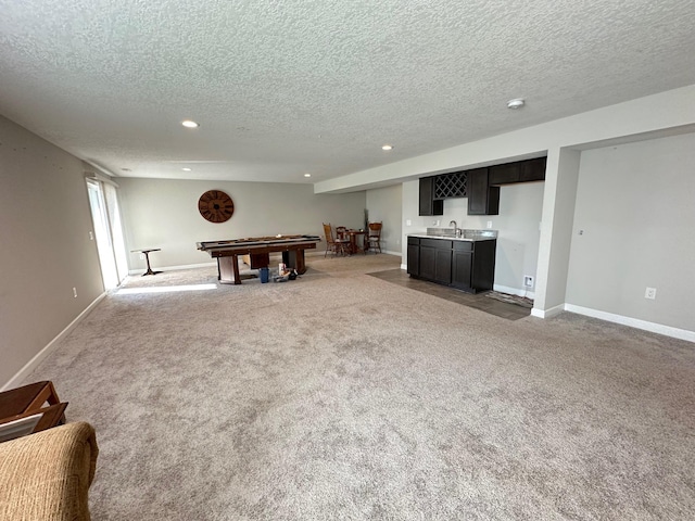 recreation room featuring pool table, carpet floors, a textured ceiling, and wet bar