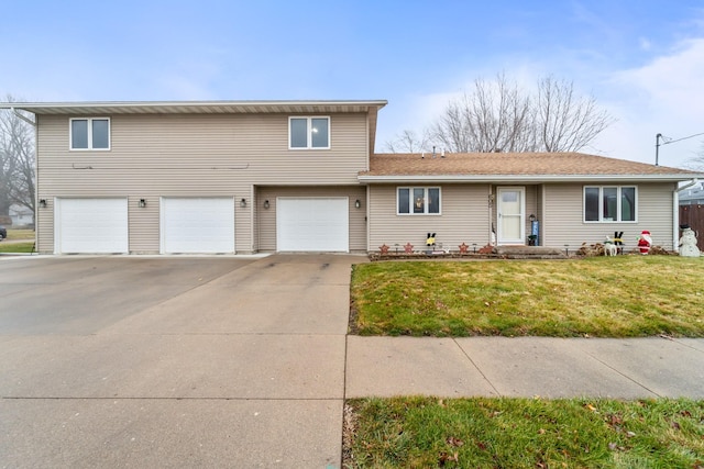 view of front facade with a garage and a front lawn