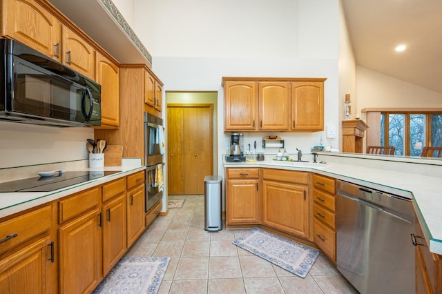 kitchen featuring light tile patterned flooring, sink, lofted ceiling, and black appliances