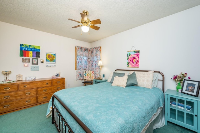 carpeted bedroom featuring ceiling fan and a textured ceiling