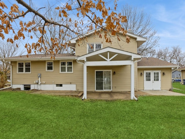 back of property featuring a patio and a lawn