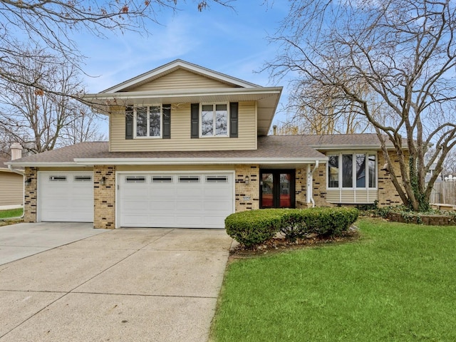 split level home with a front yard, french doors, and a garage