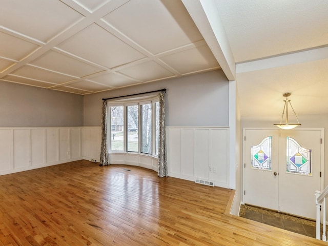 foyer with wood-type flooring and coffered ceiling