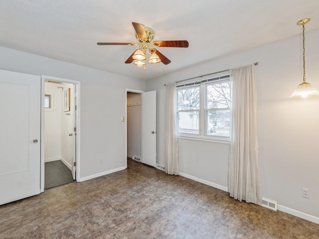 unfurnished bedroom featuring ceiling fan