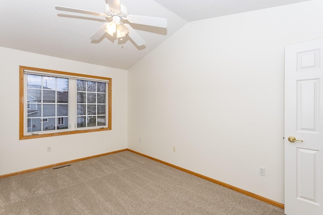 carpeted empty room with lofted ceiling and ceiling fan