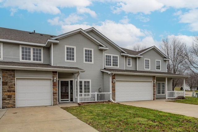 view of front of home with a front lawn and a garage