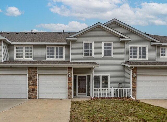 view of property featuring a front yard and a garage