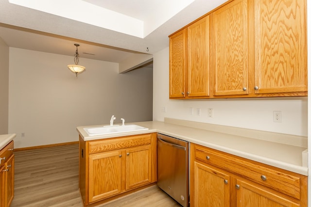 kitchen with pendant lighting, dishwasher, sink, kitchen peninsula, and light hardwood / wood-style flooring