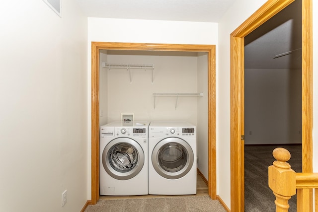 laundry room featuring separate washer and dryer and light colored carpet