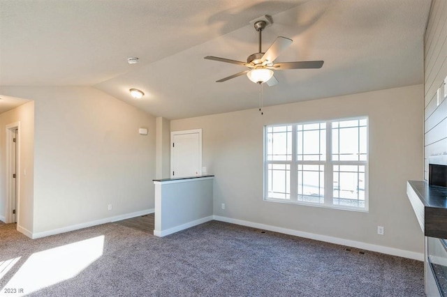 unfurnished living room with lofted ceiling, carpet, and ceiling fan