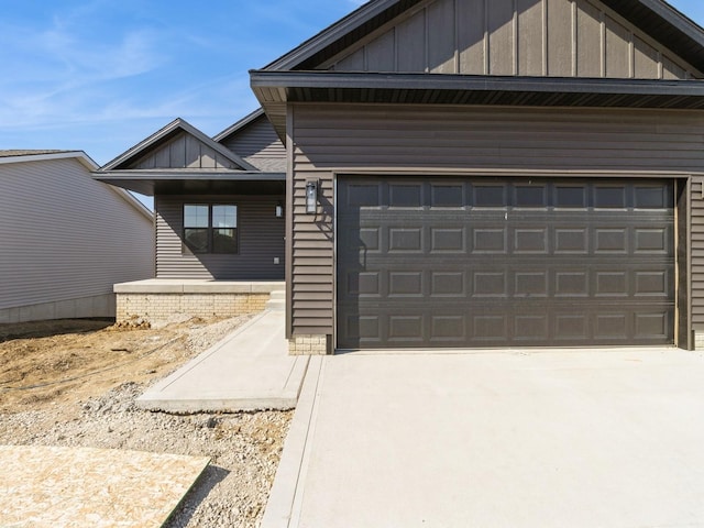 view of front of home with driveway, board and batten siding, and a garage