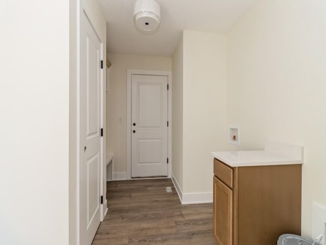 hallway with baseboards and wood finished floors