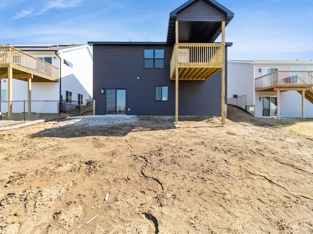 rear view of house featuring fence