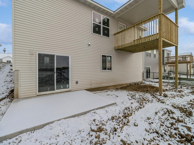 snow covered property featuring a balcony