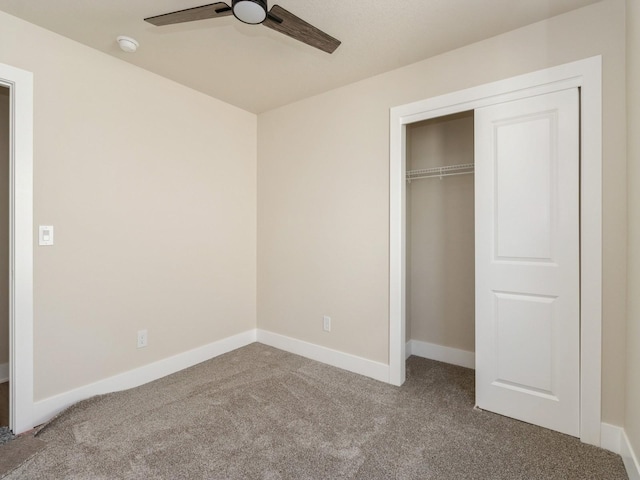 201 S Valley View Dr, Norwalk, IA 50211 - unfurnished bedroom featuring carpet, a closet, baseboards, and a ceiling fan